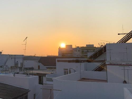 a view of the sunset from the roofs of buildings at Casa de João Francisco - Historic Center Gem in Olhão