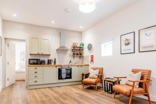 a kitchen with a counter and two chairs and a table at Your City Escape Walk Everywhere! in Worcester