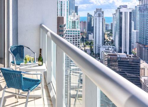 a balcony with a table and chairs and a view of the city at MVR Luxury Condo High Floor European Design in Miami