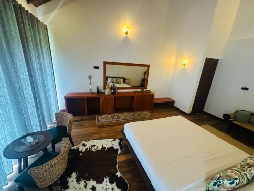 a living room with a bed and a mirror at Clara Villas Amithirigala in Avissawella