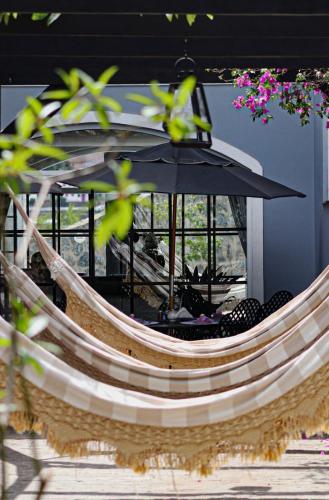 a table with an umbrella in front of a window at Vila Pugliesi Hotel Boutique in Lençóis