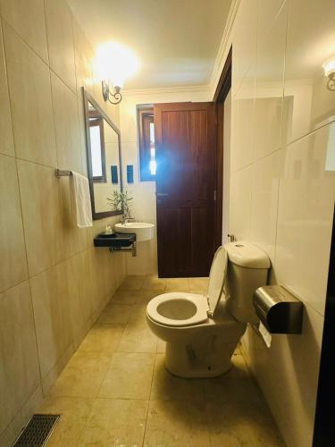 a bathroom with a toilet and a sink at Clara Villas Amithirigala in Avissawella