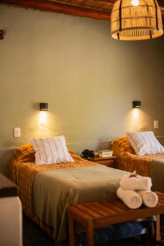 two beds in a room with towels on them at DON JUAN posada andina in Tilcara
