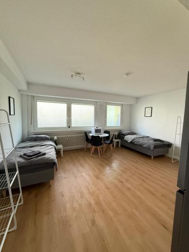 a room with two beds and a desk in it at Moderne Ferienwohnung Ratingen in Ratingen