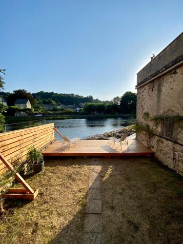 a wooden dock sitting on top of a body of water at Gîte Massibel au coeur de Brassac in Brassac