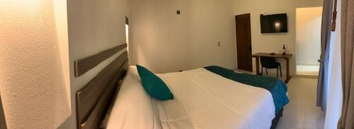 a bedroom with a bed in a room at hotel torres del viento in Villa de Leyva
