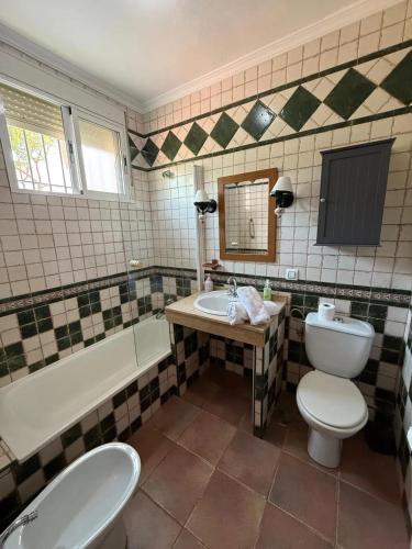 a bathroom with a toilet and a sink and a tub at Charming Villa in Punta Umbría with Private Pool in Punta Umbría