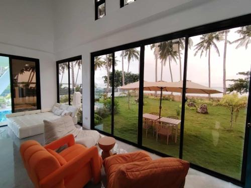 a living room with orange furniture and a view of the ocean at PRIVATE VILLA FRONT BEACH Infinity Pool in San Vicente