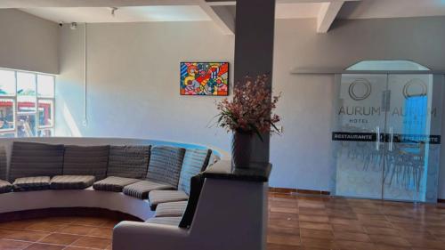 a living room with a couch and a table at Aurum Hotel in Água Boa