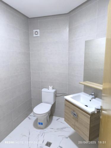 a bathroom with a toilet and a sink at modern apartment in Tangier