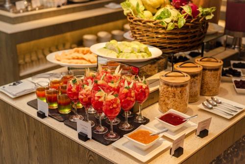 a buffet with wine glasses and food on a table at Crowne Plaza Managua by IHG in Managua