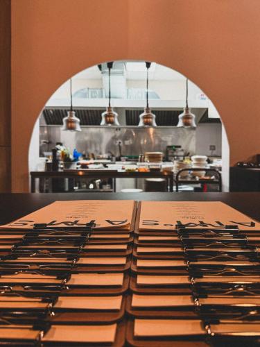 a pile of knives sitting on a table in a kitchen at Hotel Campus 90 - Free Parking in Varna City
