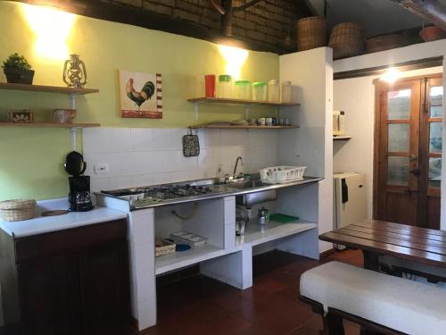 a kitchen with a sink and a stove and a table at Chalet Andino Sesquile in Suesca