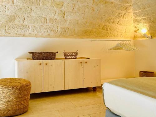 a bedroom with a bed and a cabinet with baskets on it at A Casa del Console apartment in Manfredonia