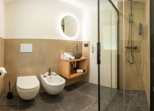 a bathroom with a toilet and a shower at Boutique Hotel Pradell in Ortisei