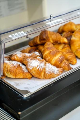 a display case filled with pastries in a bakery at Hotel Giotto in Padova