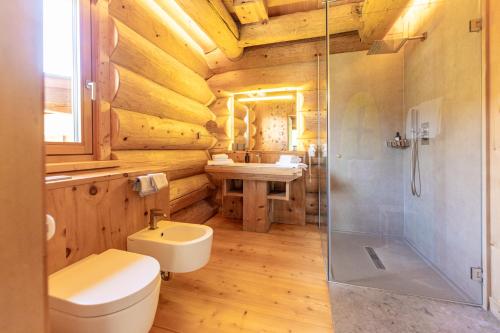 a bathroom with a toilet and a sink and a shower at Boutique Hotel Pradell in Ortisei