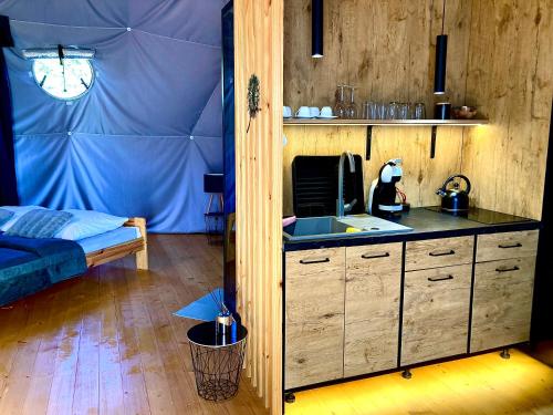 a kitchen with a sink and a bed in a room at Poziom 713 in Trzebunia