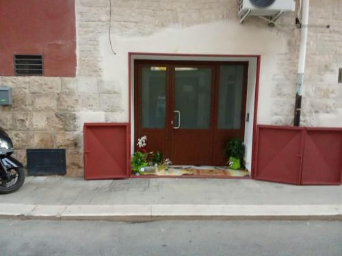 a red door of a building next to a street at Suite Impero 56 in Palo del Colle