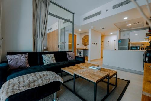 a living room with a couch and a coffee table at Modern Glass Suite with City Views Reem Island in Abu Dhabi