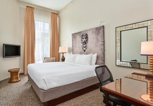 a hotel room with a bed and a desk at Crowne Plaza New Orleans French Qtr - Astor by IHG in New Orleans
