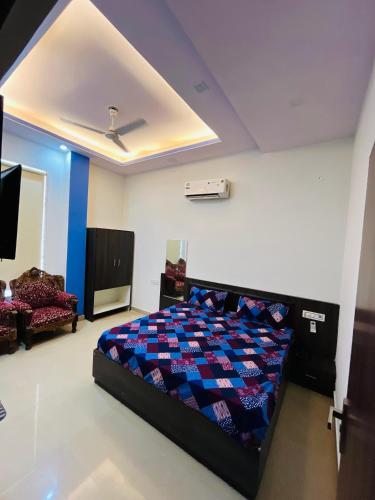 a bedroom with a bed and a tv in a room at Hotel & Resort Virasat inn in Alwar