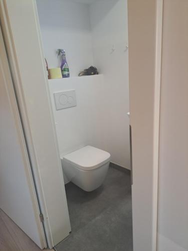 a bathroom with a toilet in a white room at Mini Loft 30 - Apartment 3 