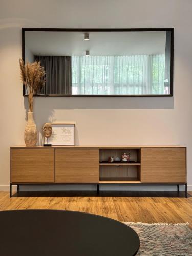 uma sala de estar com um grande espelho na parede em Dzelzavas loft em Riga