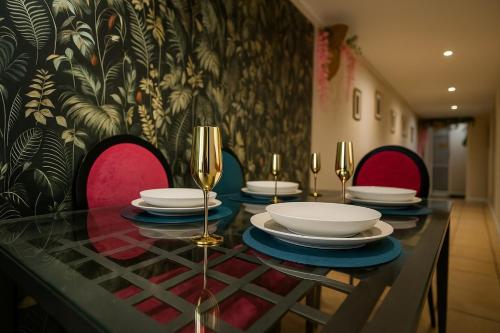 a dining table with plates and wine glasses on it at The Bunkhouse in South Shields