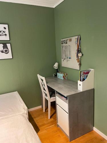 a bedroom with a desk with a bed and a bed room at Holiday home close to forest, lake and skiing in Ulricehamn