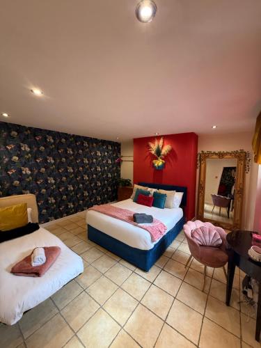 a hotel room with two beds and a mirror at The Bunkhouse in South Shields
