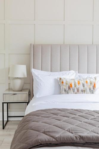 a bedroom with a white bed and a side table at Elegant One bedroom Apartment in Hounslow in Hounslow