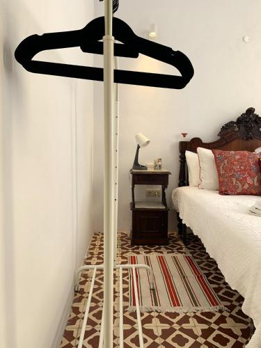 a room with a bed and a black fan at Casa de João Francisco - Historic Center Gem in Olhão