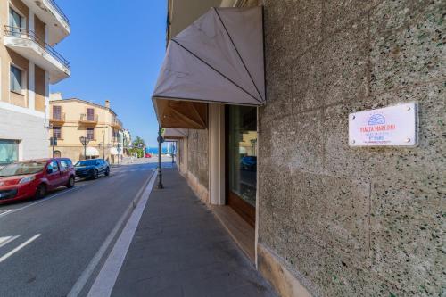 a building with an umbrella on the side of a street at BeB Piazza Marconi in Vasto