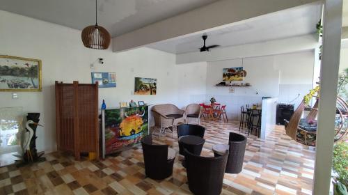 a living room with a table and some chairs at Pousada Solar Encanto do Marajó in Soure