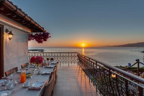 a table on a balcony with a view of the ocean at VILLA EMBIL GETARIA in Getaria
