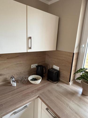 a kitchen with white cabinets and a counter top at Ferienwohnung Rømø in Bredstedt