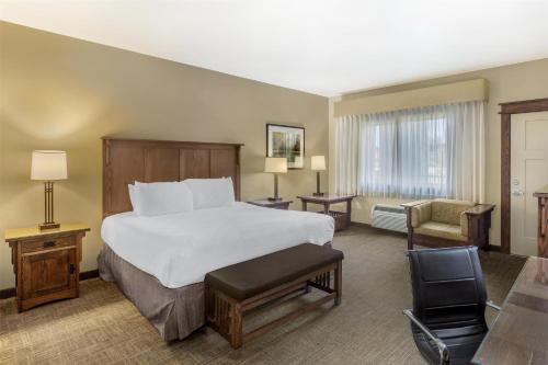 a hotel room with a bed and a chair at Best Western Plus High Country Inn in Ogden