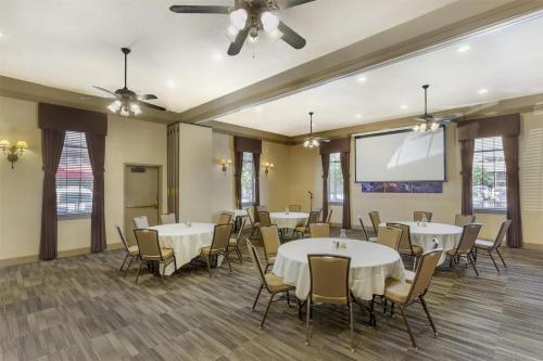 a conference room with tables and chairs and a projection screen at Best Western Plus High Country Inn in Ogden