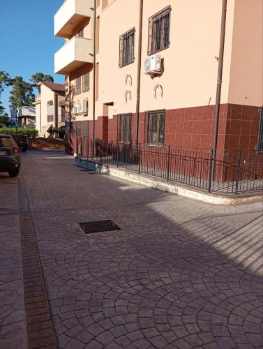 an empty street in front of a building at Zostera Apartment in Melito di Porto Salvo