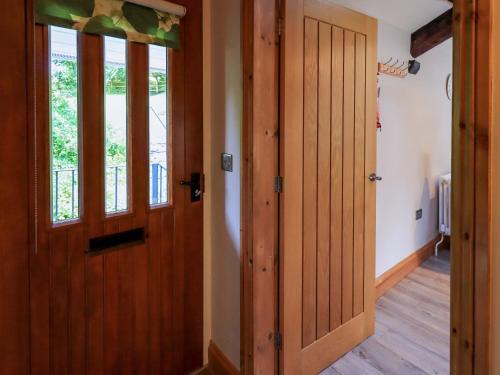an open door in a room with wooden floors at Abbots Reading Mews 2 in Lake Side