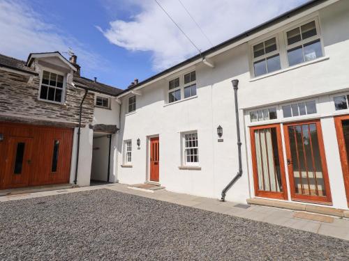 a white house with a red door and a driveway at Abbots Reading Mews 2 in Lake Side