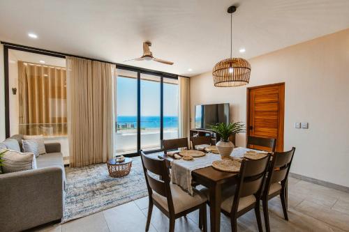 a dining room with a table and a view of the ocean at Torre San Angel Infinity Pool Arch Sunset Views in Cabo San Lucas