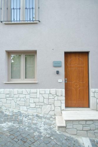 a brown door on the side of a building at NELIS HOUSE - Casa in montagna - Ateleta in Ateleta