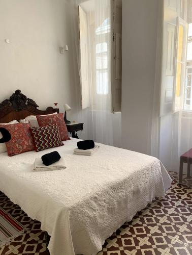 a bedroom with a bed with two towels on it at Casa de João Francisco - Historic Center Gem in Olhão
