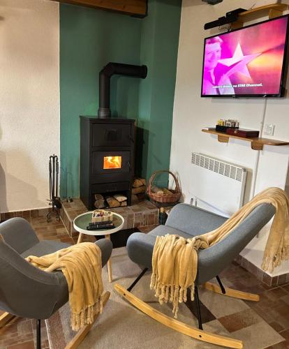 a living room with two chairs and a fireplace at Holiday home Pavic with jacuzzi and sauna in Krapina