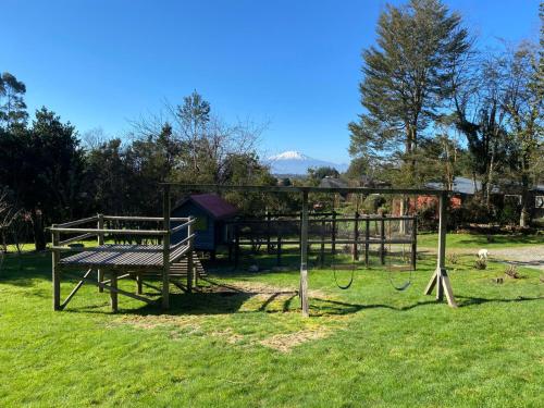 a park with a bench in the grass at Lofts Magnolias in Puerto Varas