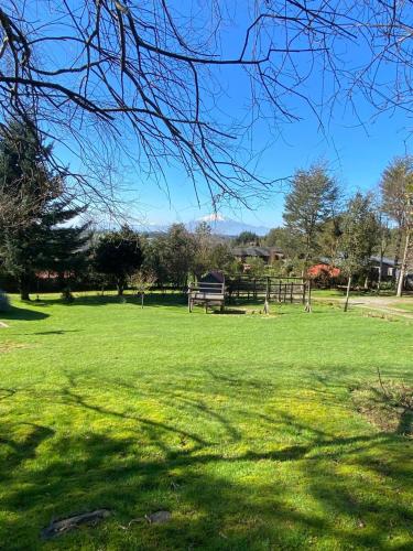 a grassy field with a park with a playground at Lofts Magnolias in Puerto Varas