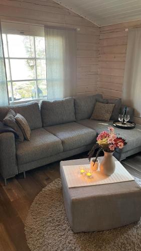 a living room with a couch and a table at Siulakumpu Cabin in Inari