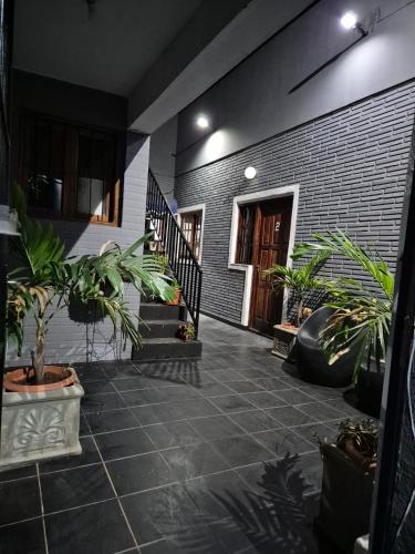 a courtyard with potted plants in a house at Dpto Céntrico con Balcón Dpto 1 in Puerto Iguazú